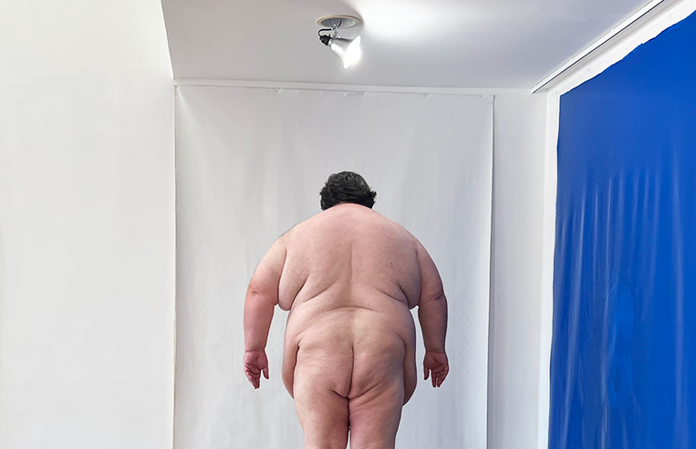 Paul Kolazinski's preforms, Shape, while standing in front of a blank canvas.